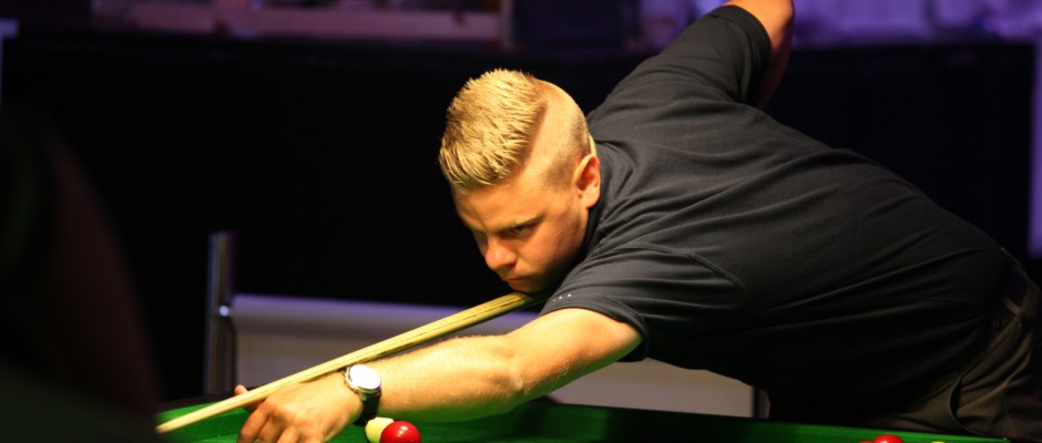 A young player lining up a red
